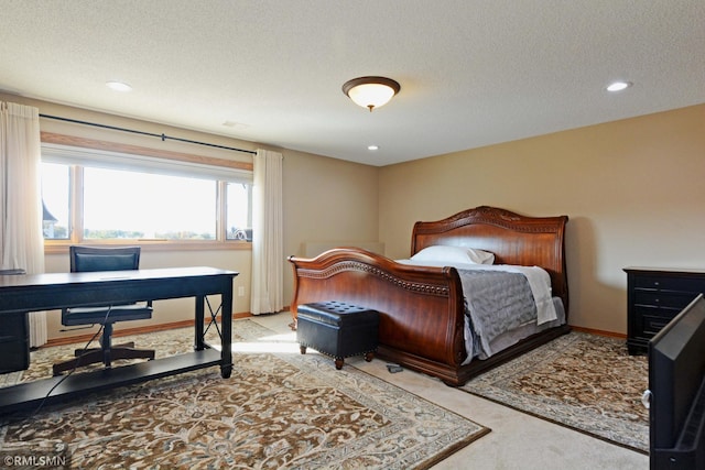 bedroom with light carpet and a textured ceiling