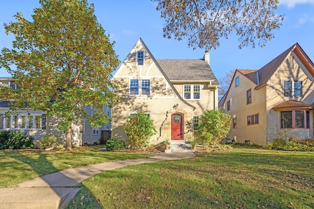 tudor home with a front yard