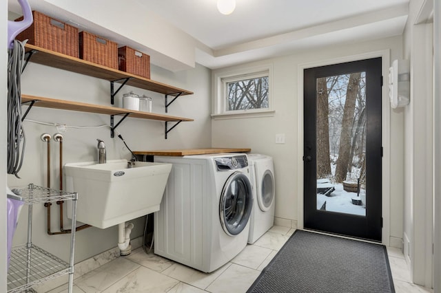 laundry room featuring washing machine and dryer and sink