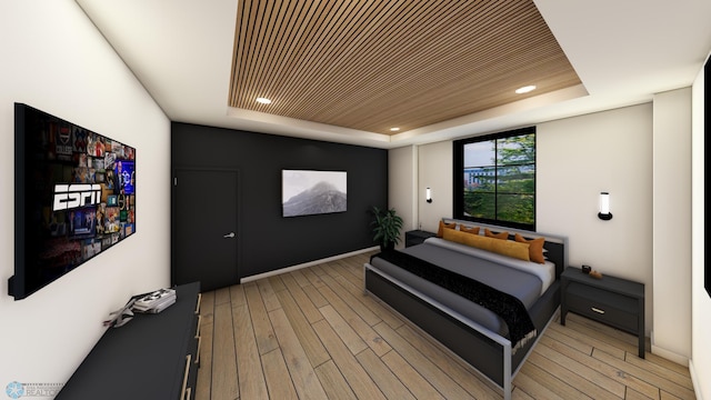 bedroom featuring a tray ceiling, light wood-style floors, and recessed lighting