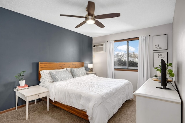 carpeted bedroom with a textured ceiling, ceiling fan, and a wall mounted air conditioner