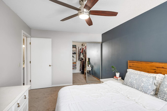 carpeted bedroom featuring a closet and ceiling fan