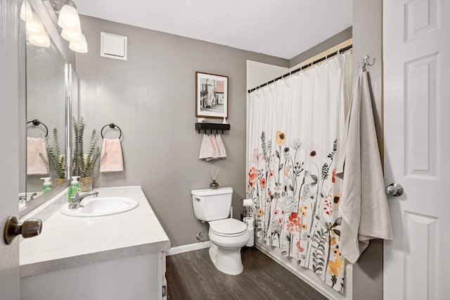 bathroom with hardwood / wood-style floors, vanity, and toilet