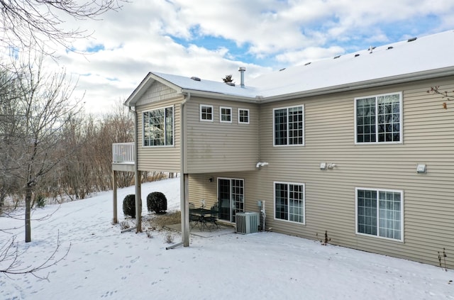 snow covered property featuring central air condition unit