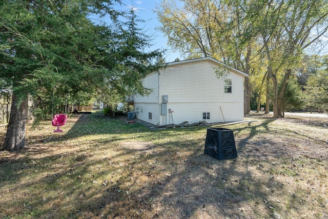 view of property exterior featuring a lawn and central AC