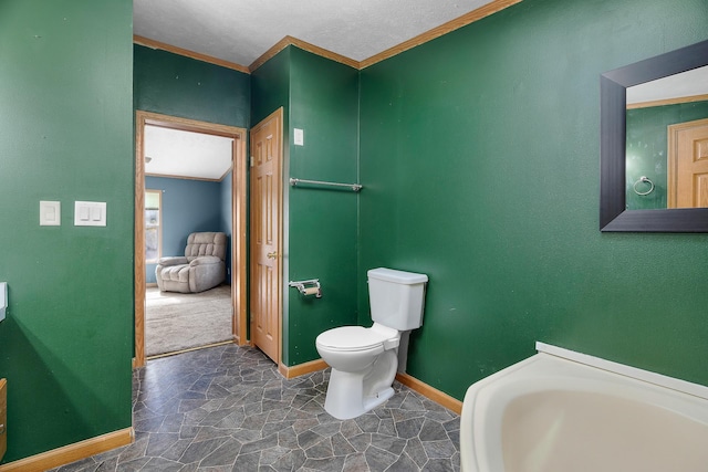 bathroom featuring toilet and crown molding