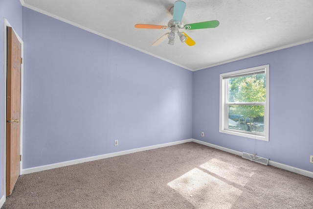 unfurnished room with carpet, a textured ceiling, ceiling fan, and crown molding