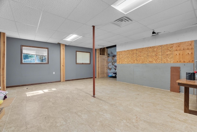 basement featuring a paneled ceiling