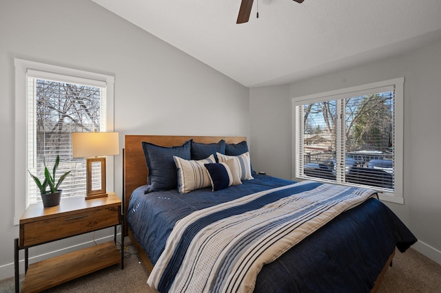 bedroom with ceiling fan, carpet floors, vaulted ceiling, and multiple windows