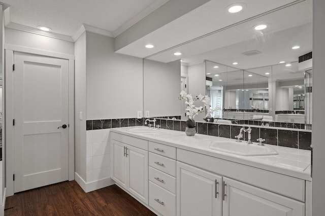 bathroom featuring vanity, crown molding, and hardwood / wood-style flooring