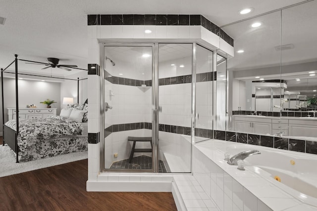 bathroom with hardwood / wood-style flooring, ceiling fan, vanity, and independent shower and bath