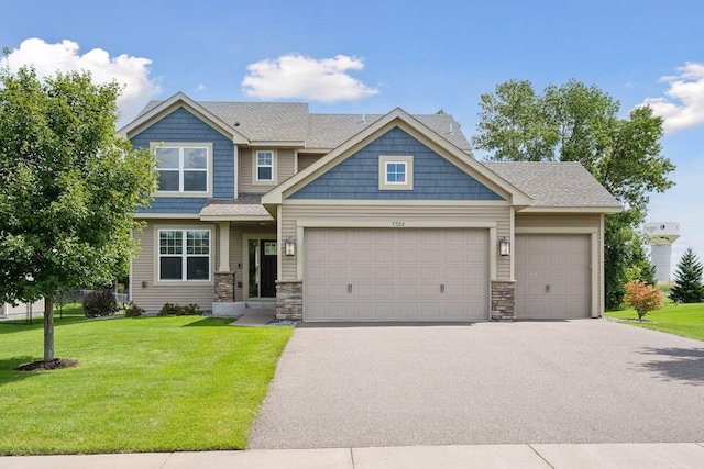 craftsman house featuring a front yard and a garage