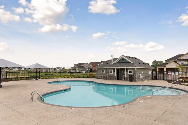 view of swimming pool with central air condition unit and a patio area