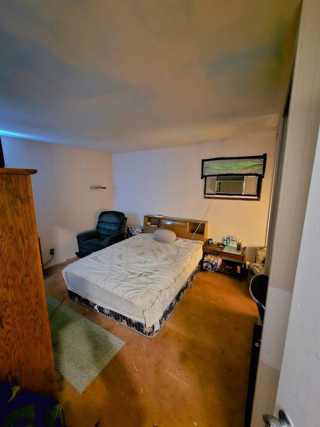 bedroom featuring cooling unit and concrete floors