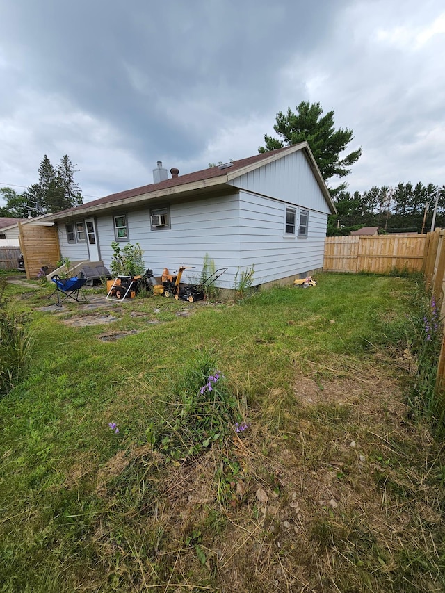 back of property with a lawn