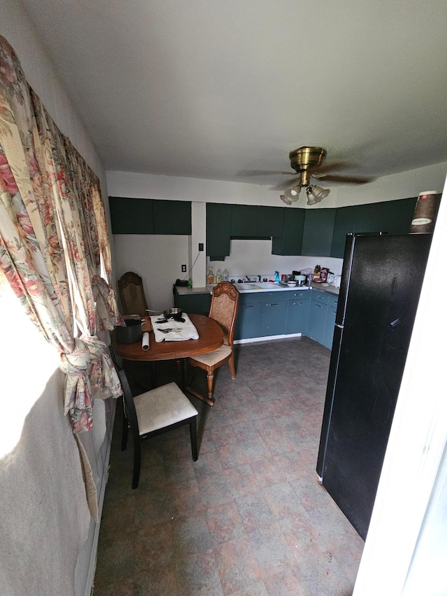 kitchen featuring black fridge and ceiling fan