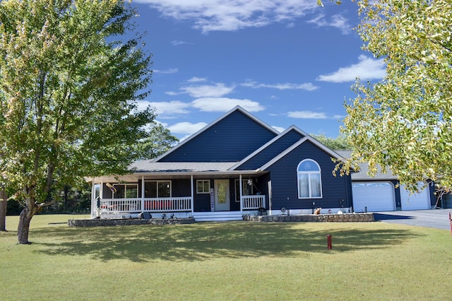 view of front of home featuring covered porch, a front yard, and a garage