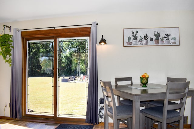dining room with visible vents and wood finished floors