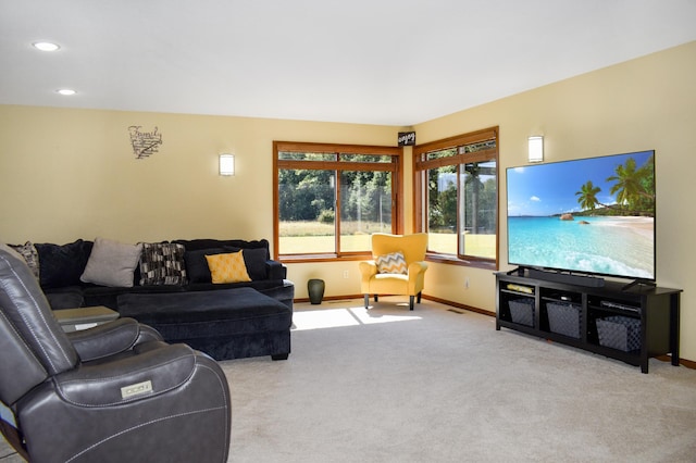 carpeted living room featuring baseboards and recessed lighting