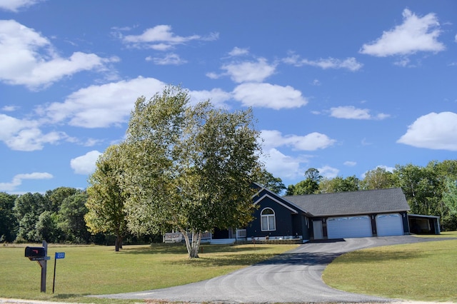 view of front of property with aphalt driveway, a garage, and a front yard