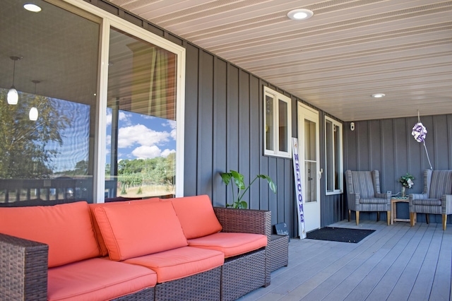 wooden terrace featuring an outdoor living space