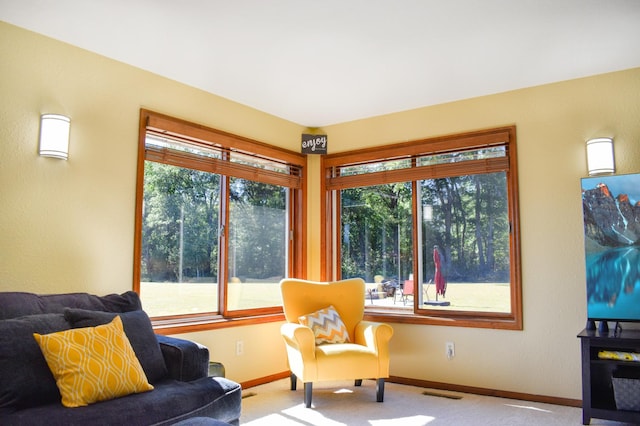 sitting room with baseboards, plenty of natural light, visible vents, and carpet floors