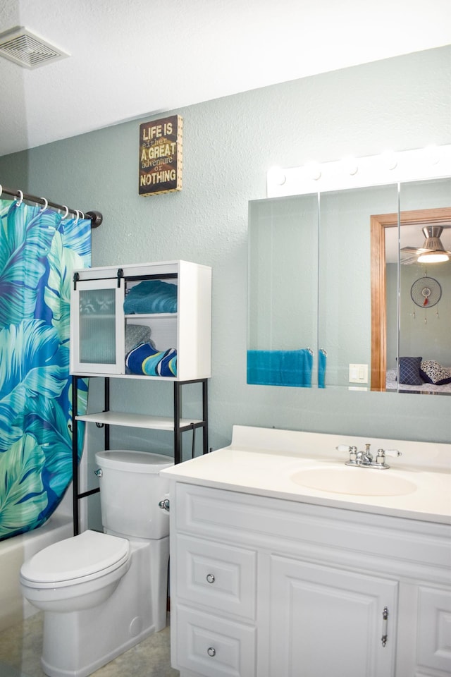 bathroom with toilet, vanity, visible vents, a textured wall, and shower / bath combination with curtain