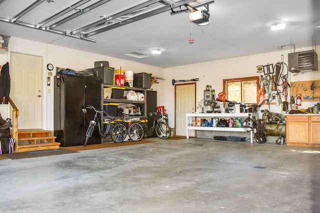 garage featuring a garage door opener and a workshop area