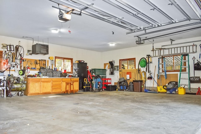 garage featuring a garage door opener and a workshop area