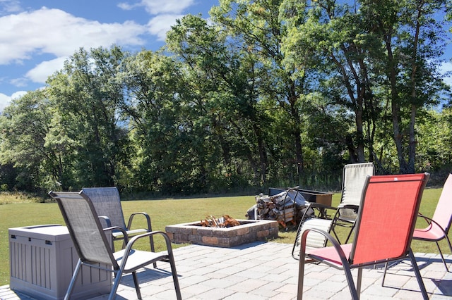 deck featuring an outdoor fire pit, a yard, and a patio