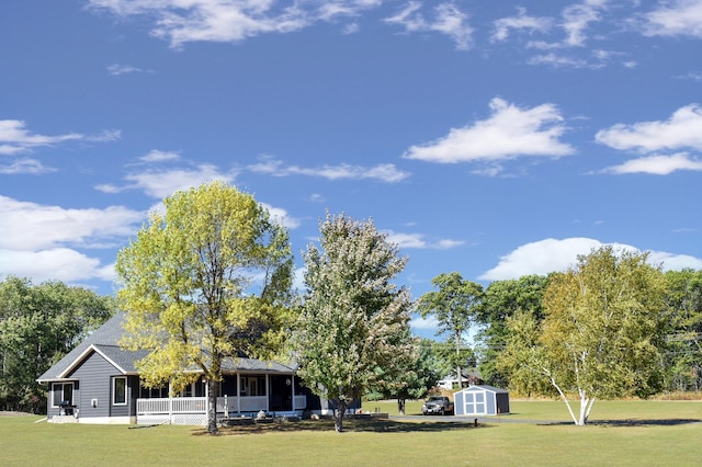 exterior space featuring a porch, an outbuilding, and a shed