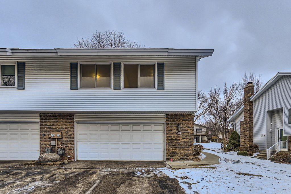 view of snowy exterior featuring a garage