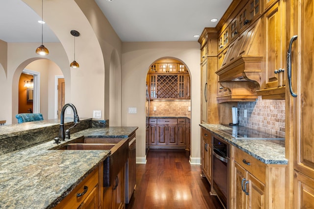 1201 Yale Pl Unit 2303, Minneapolis, MN 55403 - kitchen with a sink, dark stone counters, dark wood-type flooring, backsplash, and appliances with stainless steel finishes