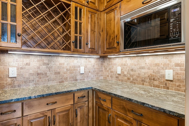 1201 Yale Pl Unit 2303, Minneapolis, MN 55403 - kitchen featuring glass insert cabinets, brown cabinetry, and black microwave