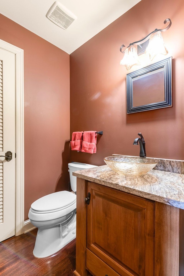 1201 Yale Pl Unit 2303, Minneapolis, MN 55403 - bathroom featuring toilet, vanity, visible vents, and wood finished floors