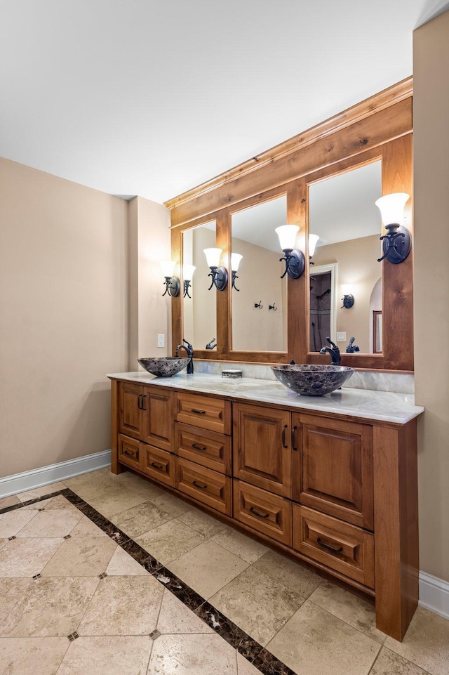 1201 Yale Pl Unit 2303, Minneapolis, MN 55403 - full bath with a sink, double vanity, and baseboards