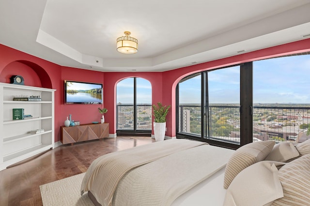 1201 Yale Pl Unit 2303, Minneapolis, MN 55403 - bedroom with a tray ceiling, baseboards, visible vents, and wood finished floors