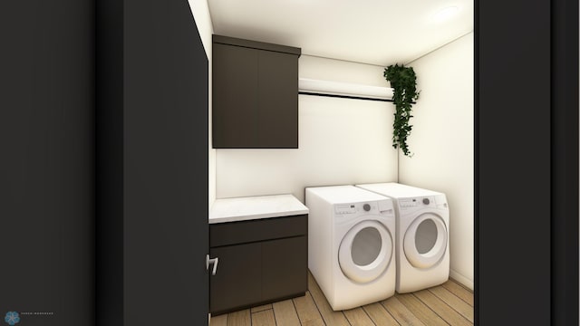 clothes washing area featuring washer and dryer, light hardwood / wood-style floors, and cabinets