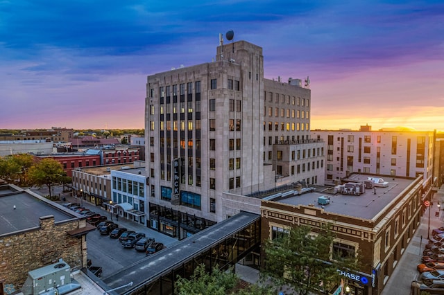 property at dusk featuring a city view