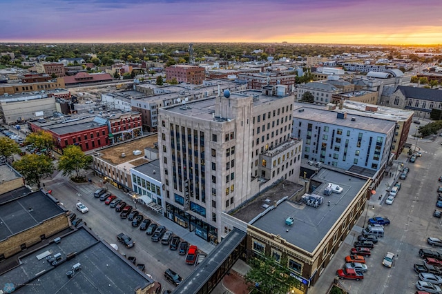 aerial view at dusk featuring a city view