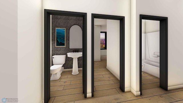 118 Broadway N Unit 701, Fargo, ND 58102 - bathroom with wood tiled floors and toilet