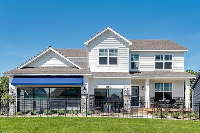 view of front of home with a porch and a front lawn