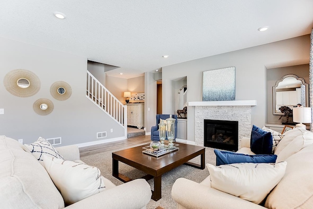 living room with a fireplace and light hardwood / wood-style flooring