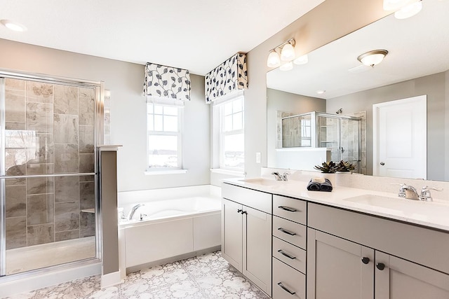 bathroom featuring shower with separate bathtub and vanity