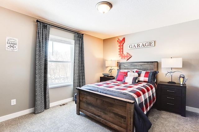 bedroom with carpet floors and a textured ceiling