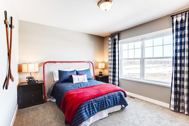 carpeted bedroom featuring a textured ceiling