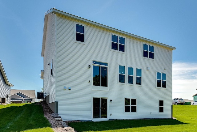 rear view of property featuring a yard