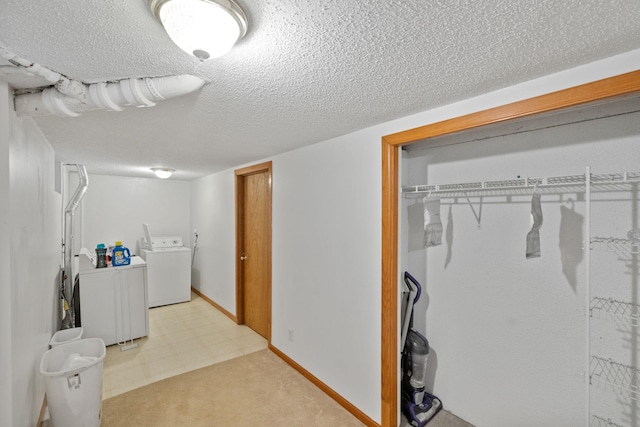 washroom with washer / clothes dryer and a textured ceiling