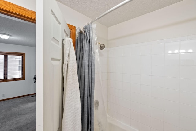 bathroom featuring shower / tub combo and a textured ceiling