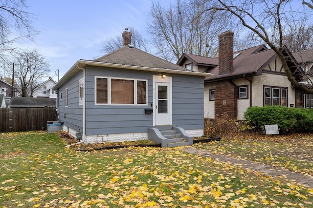 bungalow-style home featuring a front lawn